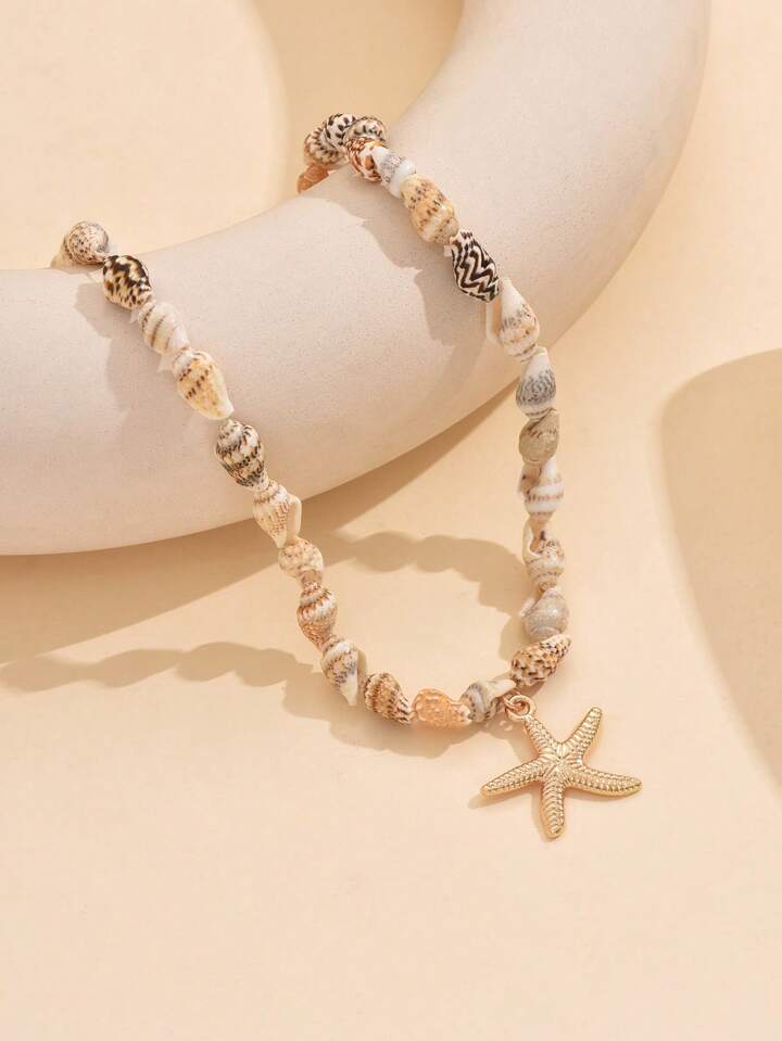 سلسلة خرز صدف طبيعي مع نجمة بحر ذهبية