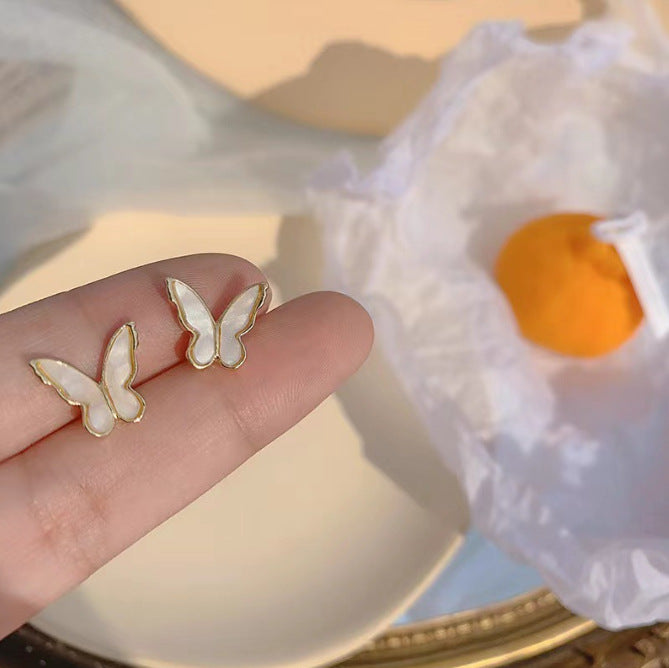 حلق فراشة لؤلؤي بإطار ذهبي – أنوثة ناعمة وأناقة رقيقة