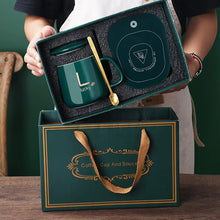 مج بورسلين حراري مزود بقاعدة تسخين ومعلقة ستانلس وشنطة هدايا