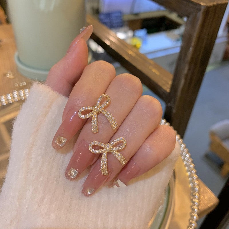 حلق نسائي فيونكة مطلي بماء الذهب مرصع بفصوص لامعة – تصميم أنيق